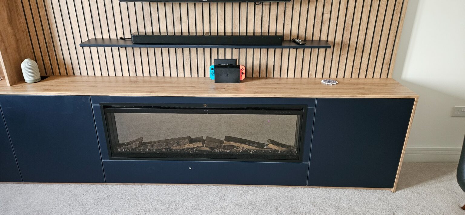 Bespoke Media Unit in Grandhome, Aberdeen 10 Electric fireplace integrated into the dark base cabinetry of a bespoke media unit