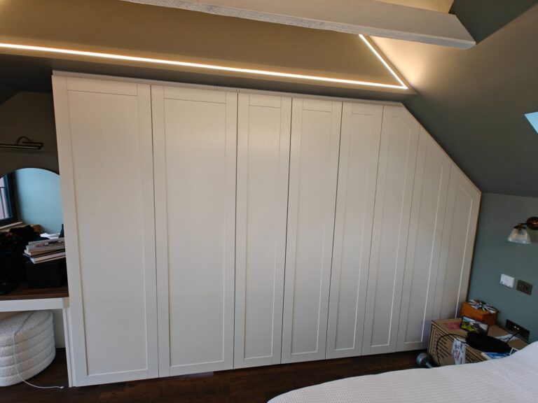 Closed white hinged wardrobe doors forming a seamless bedroom wall in Murrayfield, Edinburgh