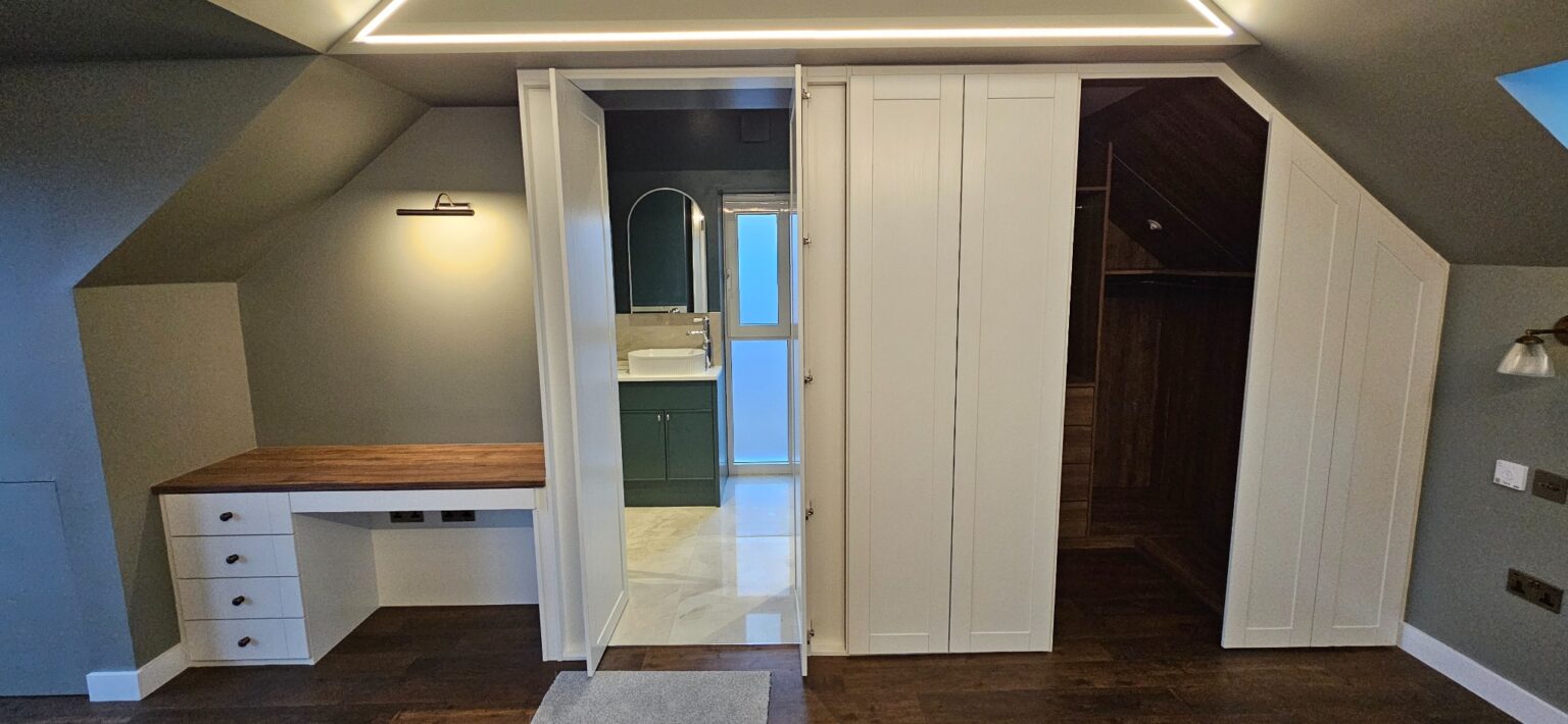 Seamless fitted wardrobe wall with concealed ensuite bathroom access