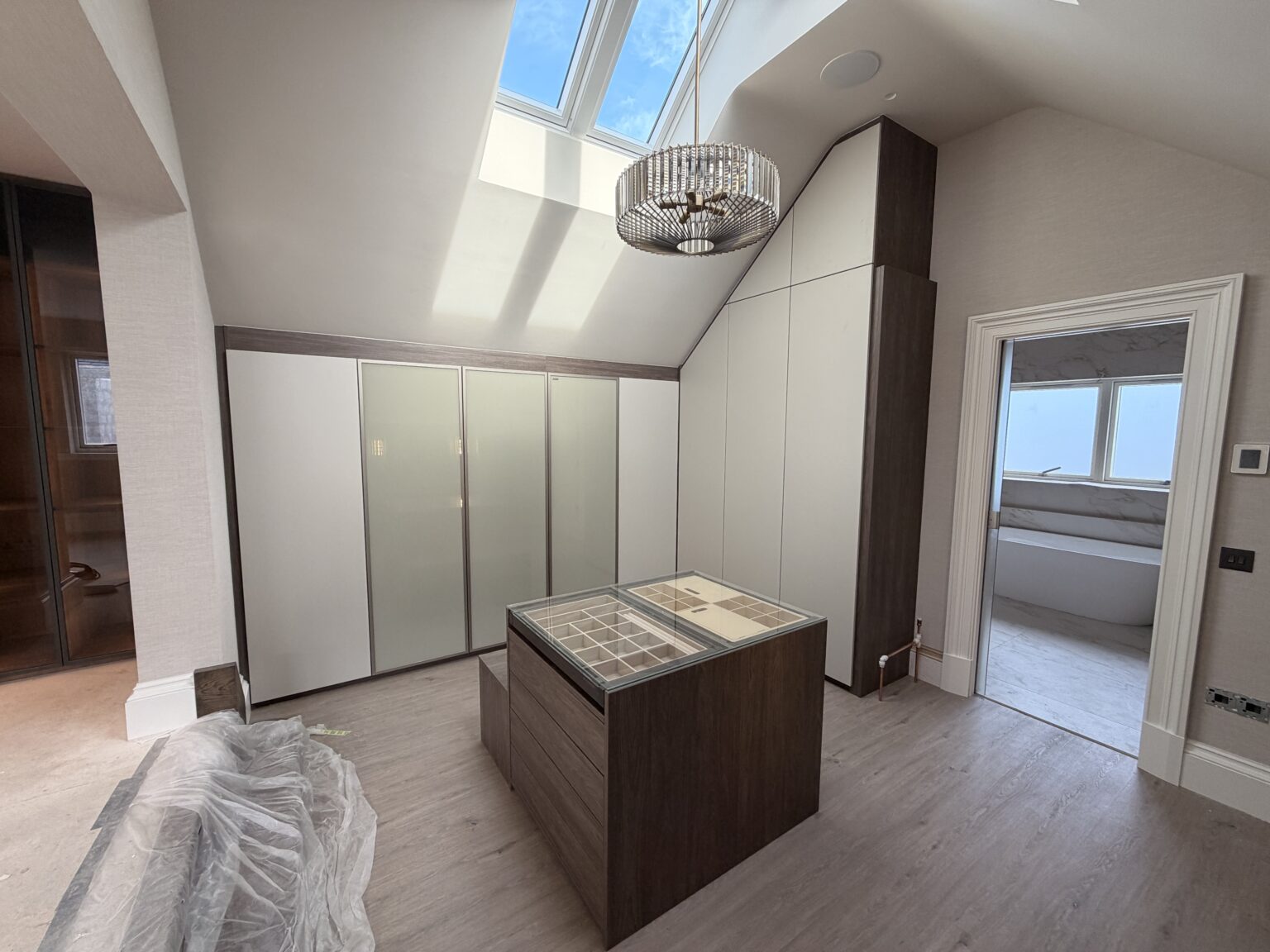 Sloped Ceiling Wardrobes: Make Every Inch Count 1 Luxury walk in wardrobe under a sloped ceiling by Komandor Scotland.
