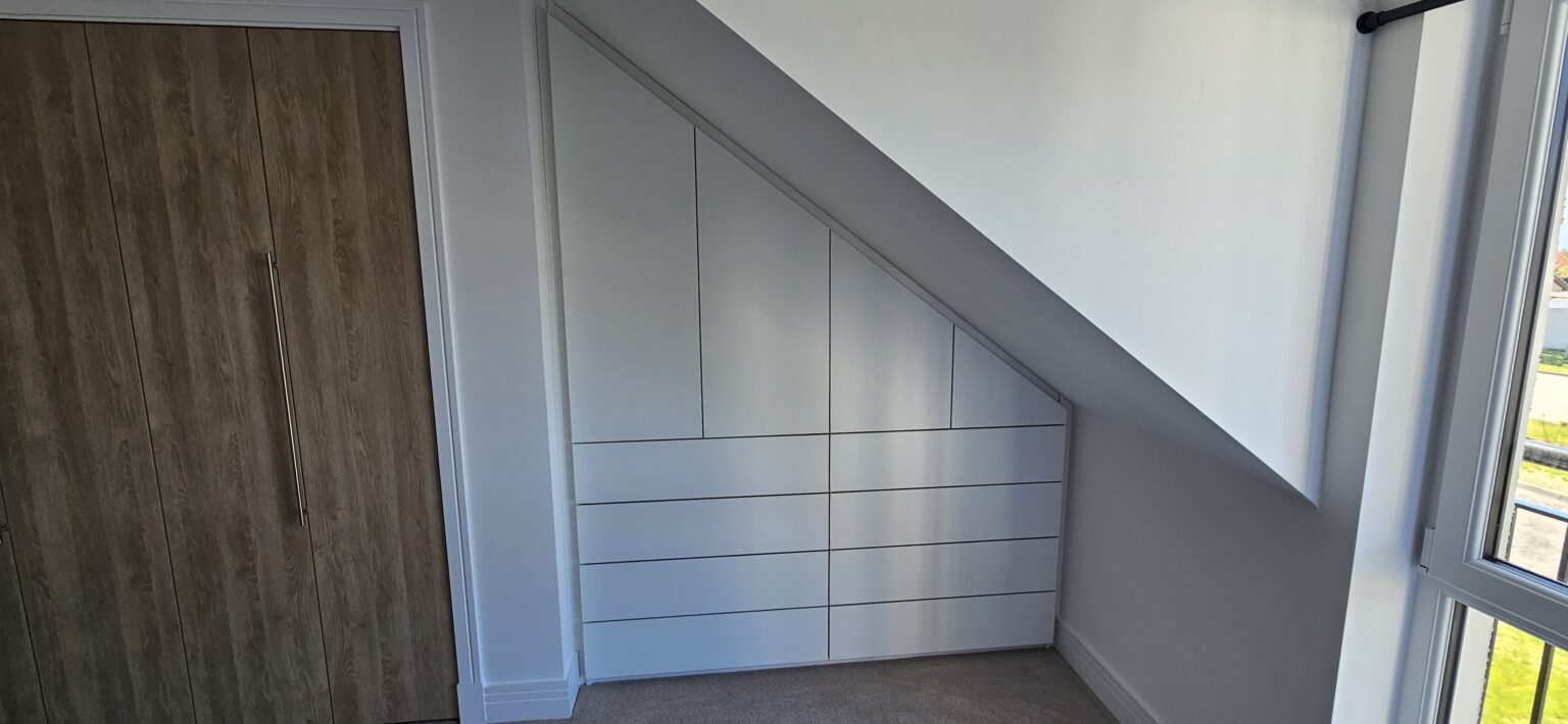 Sloped Ceiling Wardrobes: Make Every Inch Count 3 Sloped ceiling fitted wardrobe with internal drawer storage by Komandor Scotland.