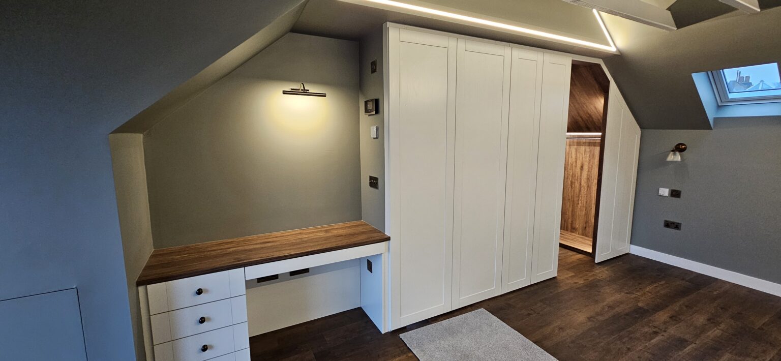 Sloped Ceiling Wardrobes: Make Every Inch Count 4 Sloped ceiling wardrobe with integrated dressing table by Komandor Scotland.